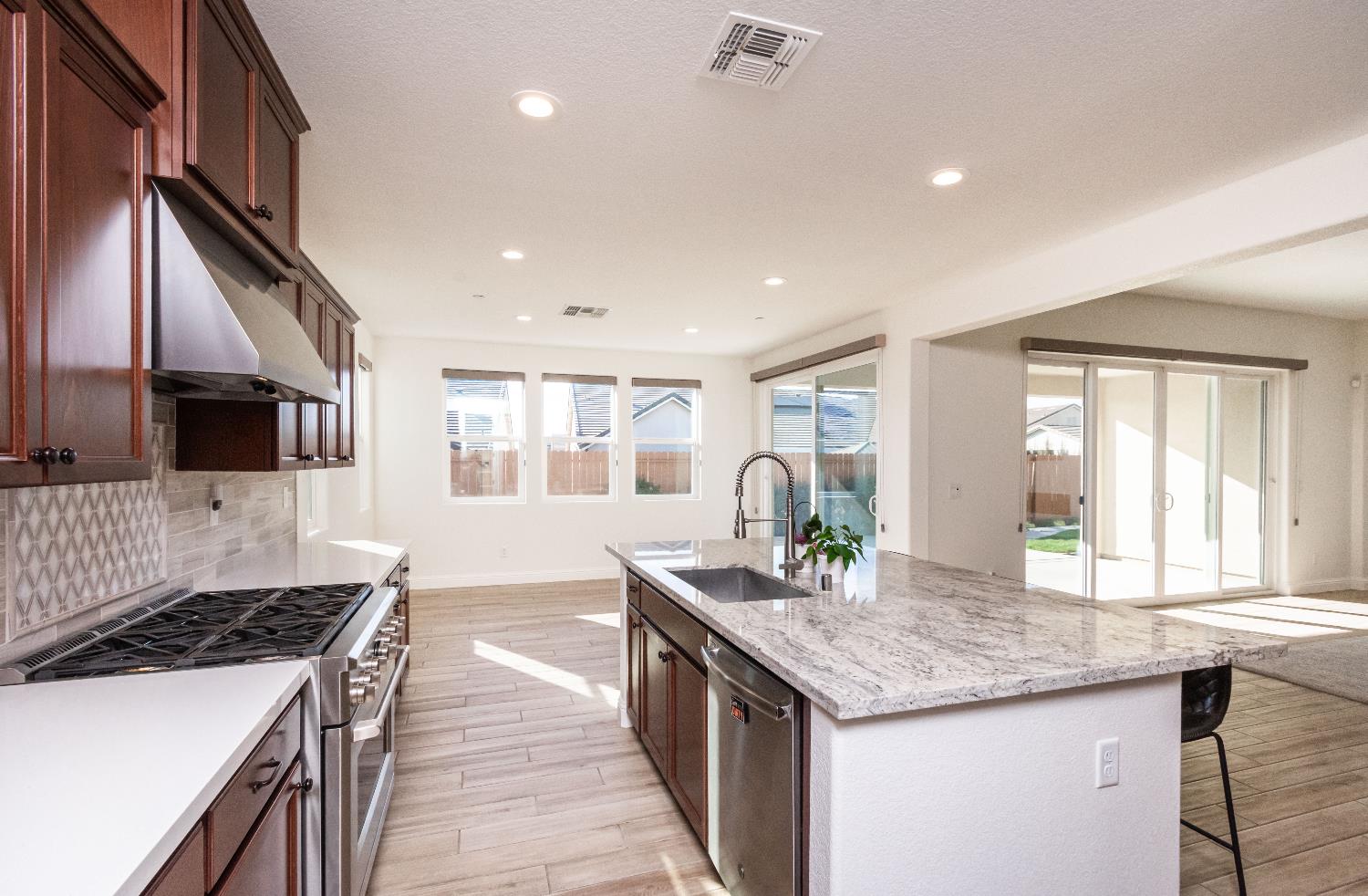 124 Basile Court Lincoln, CA 95648 - Photo 20 of 64 a kitchen with granite countertop a stove and a sink