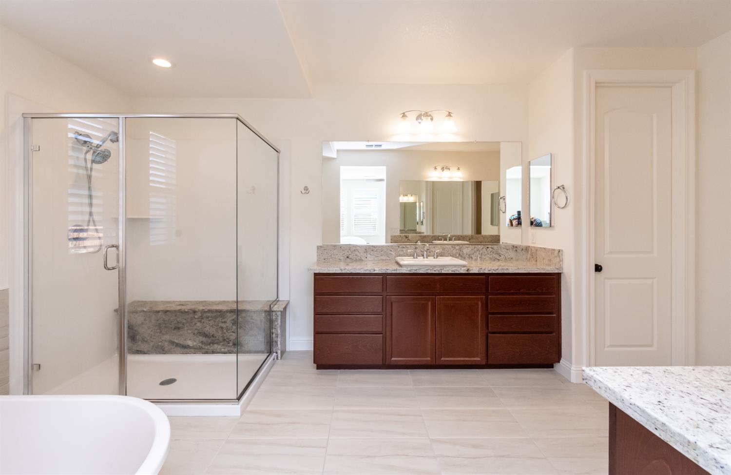 124 Basile Court Lincoln, CA 95648 - Photo 22 of 55 bathroom with vanity, a shower stall, light tile patterned floors, and a soaking tub