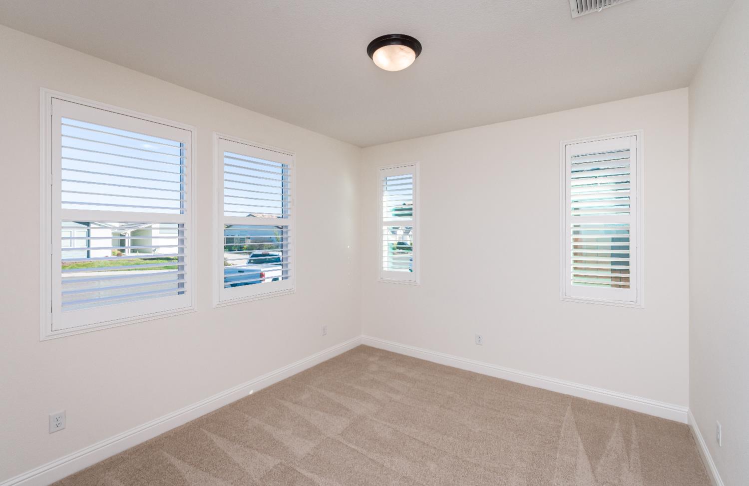 124 Basile Court Lincoln, CA 95648 - Photo 26 of 55 unfurnished room featuring healthy amount of natural light and light carpet