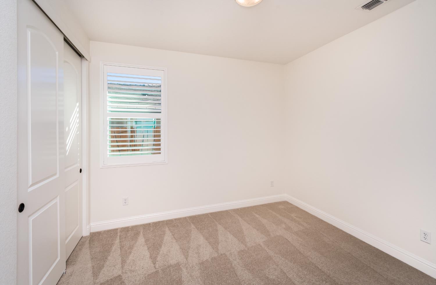 124 Basile Court Lincoln, CA 95648 - Photo 32 of 55 unfurnished bedroom with light carpet and a closet