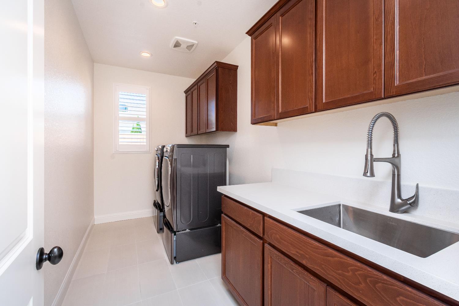 124 Basile Court Lincoln, CA 95648 - Photo 44 of 64 a kitchen with stainless steel appliances granite countertop a sink refrigerator and cabinets