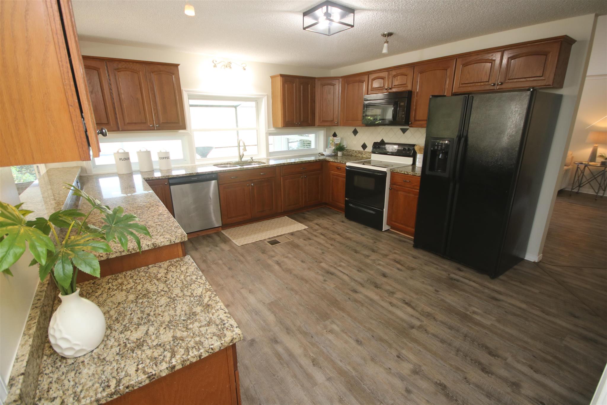 5425 Rowe Trail Pace, FL 32571 - Photo 28 of 50 a kitchen with stainless steel appliances granite countertop wooden cabinets a refrigerator a sink a stove a microwave and island
