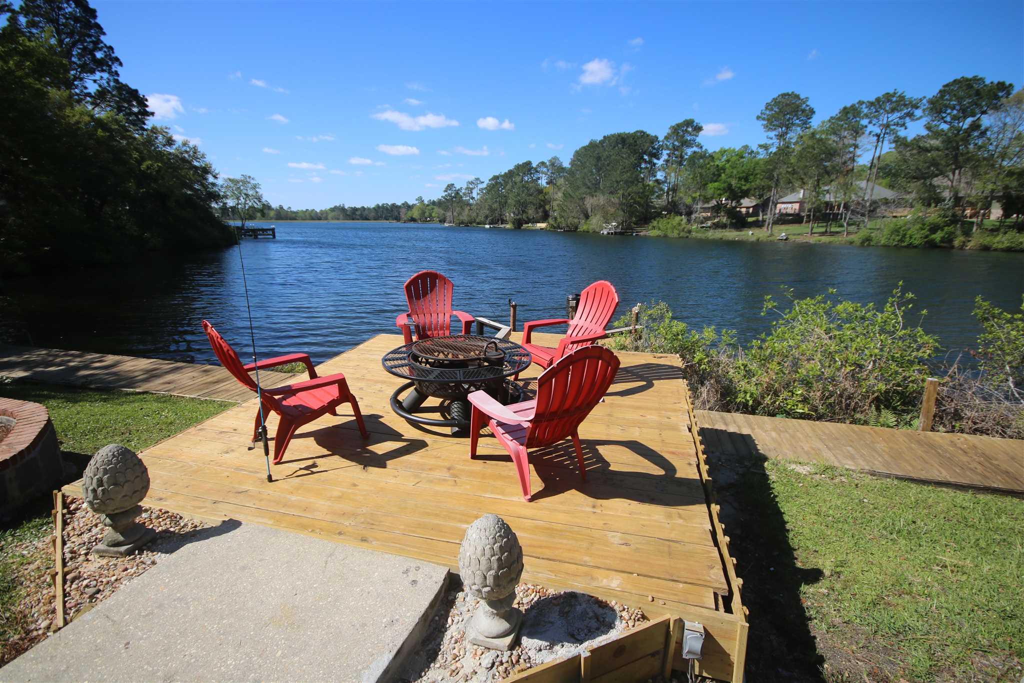 5425 Rowe Trail Pace, FL 32571 - Photo 7 of 50 a view of a lake with a table and chairs