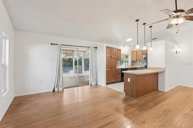 a large kitchen with kitchen island a sink stainless steel appliances and cabinets