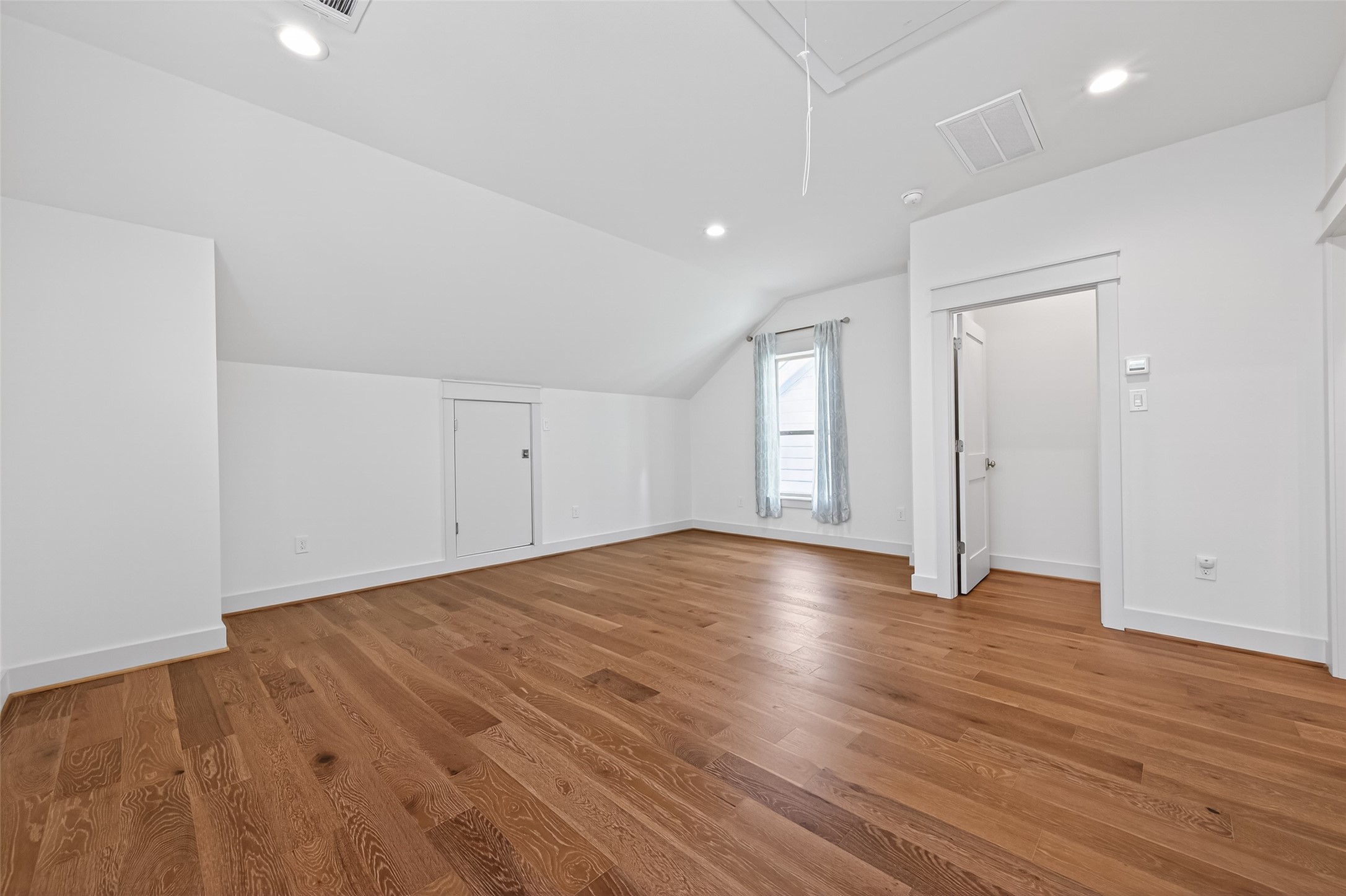 515 West 25th Street Houston, TX 77008 - Photo 24 of 35 Third-floor bonus room includes attic access, two utility closets with locks, and a Minka-Aire large-room fan in flat white, all set above the continuation of the beautiful 5” French Oak hardwood floors.