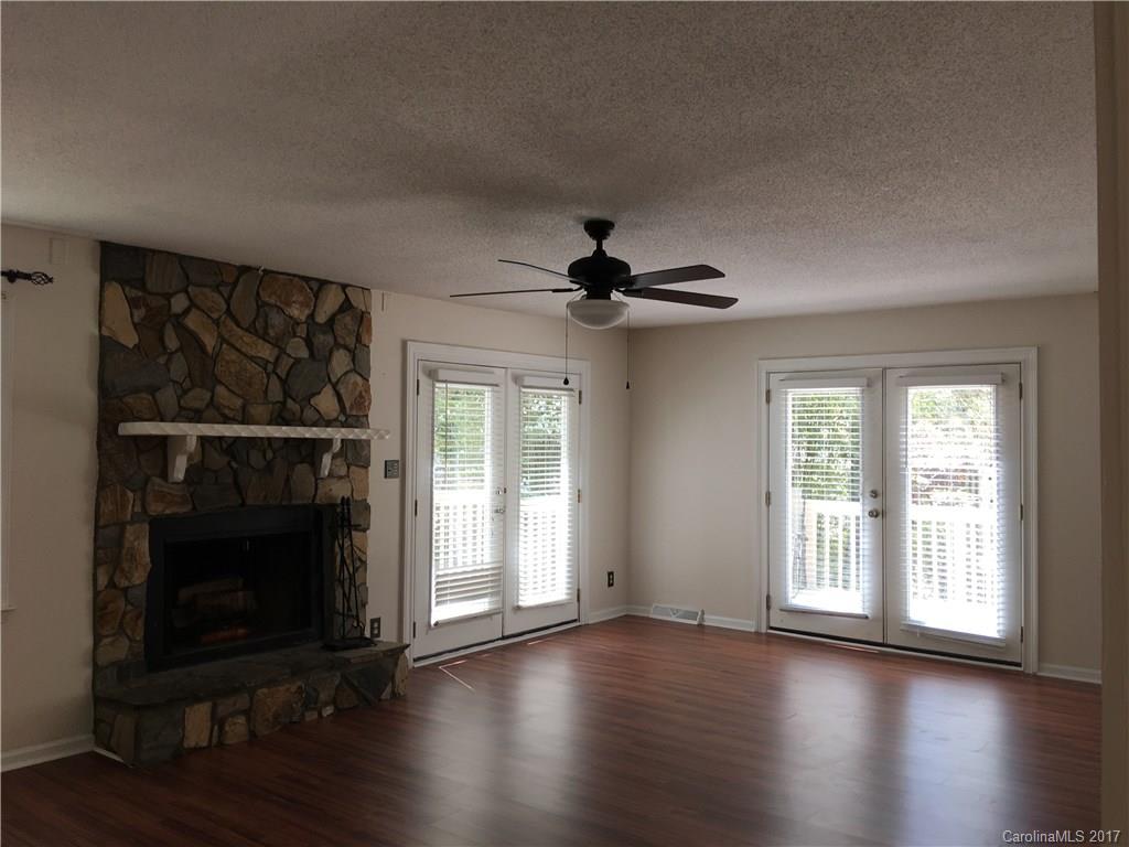 3085 Point Clear Drive Tega Cay, SC 29708 - Photo 4 of 21 a view of an empty room with wooden floor fireplace and a window