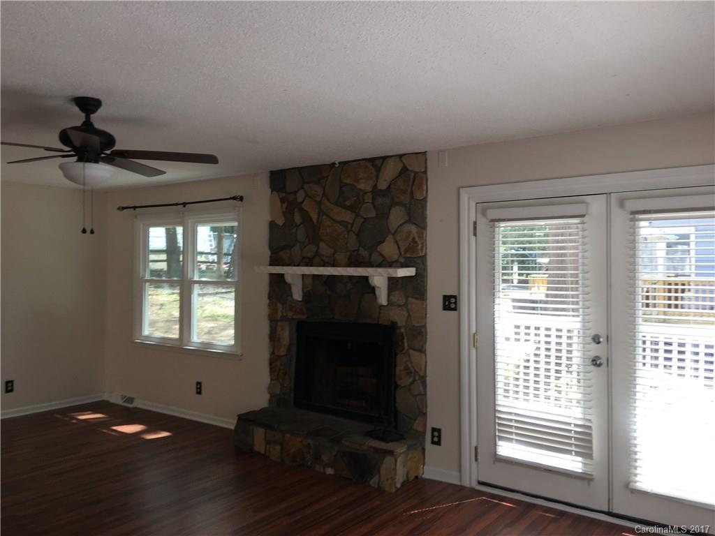 3085 Point Clear Drive Tega Cay, SC 29708 - Photo 5 of 21 a view of an empty room with wooden floor and a window