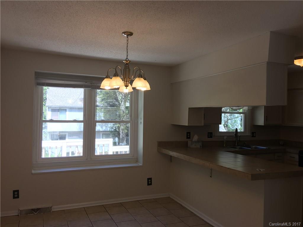 3085 Point Clear Drive Tega Cay, SC 29708 - Photo 6 of 21 a kitchen with a sink and chandelier