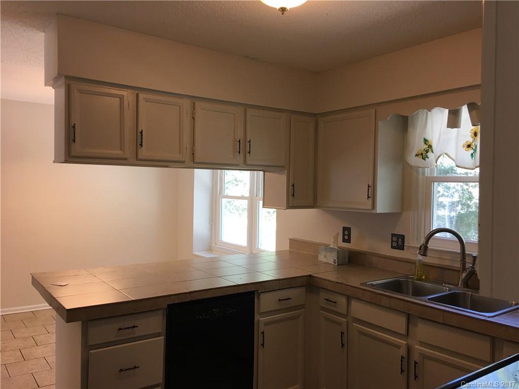 3085 Point Clear Drive Tega Cay, SC 29708 - Photo 7 of 21 a kitchen with a sink cabinets and window