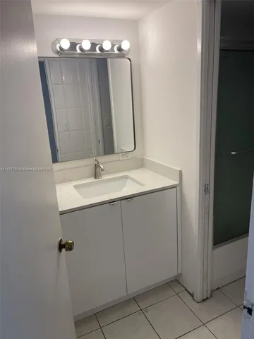 a bathroom with a sink vanity and mirror