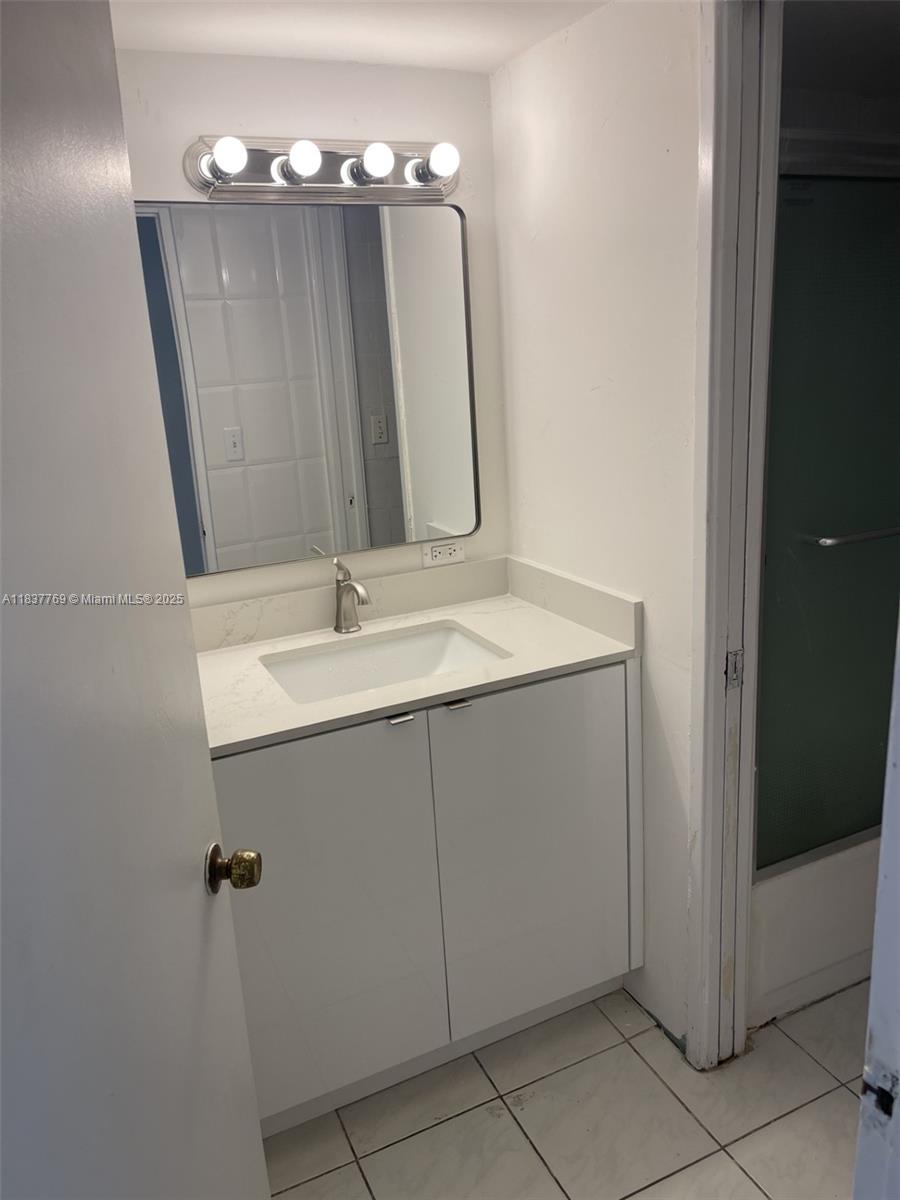 17011 North Bay Road, Unit 406 Sunny Isles Beach, FL 33160 - Photo 5 of 12 a bathroom with a sink vanity and mirror