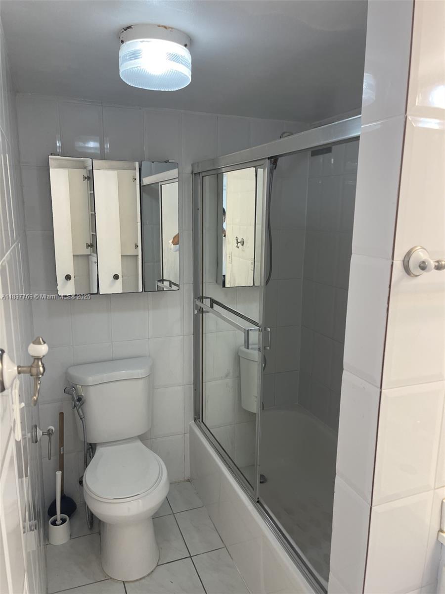 17011 North Bay Road, Unit 406 Sunny Isles Beach, FL 33160 - Photo 6 of 12 a bathroom with a toilet and a shower