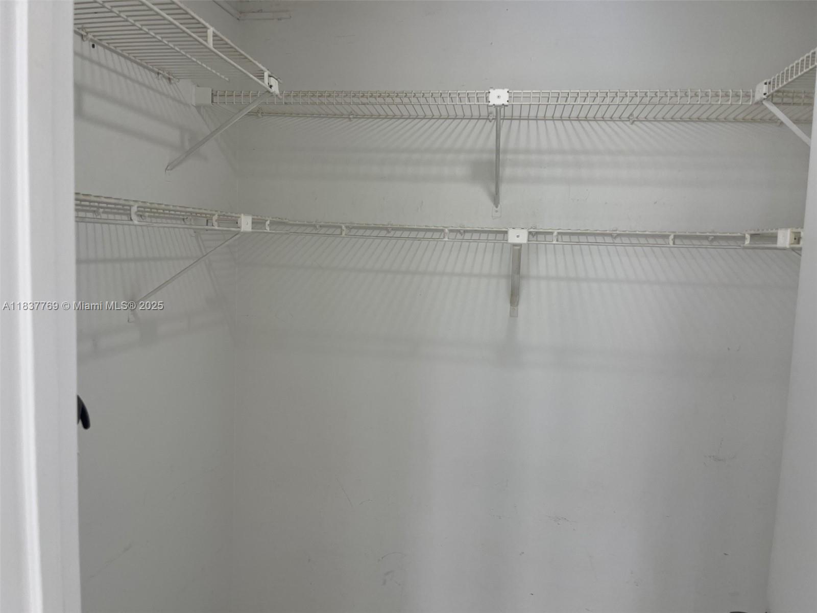 17011 North Bay Road, Unit 406 Sunny Isles Beach, FL 33160 - Photo 8 of 12 a view of a room with racks on the wall