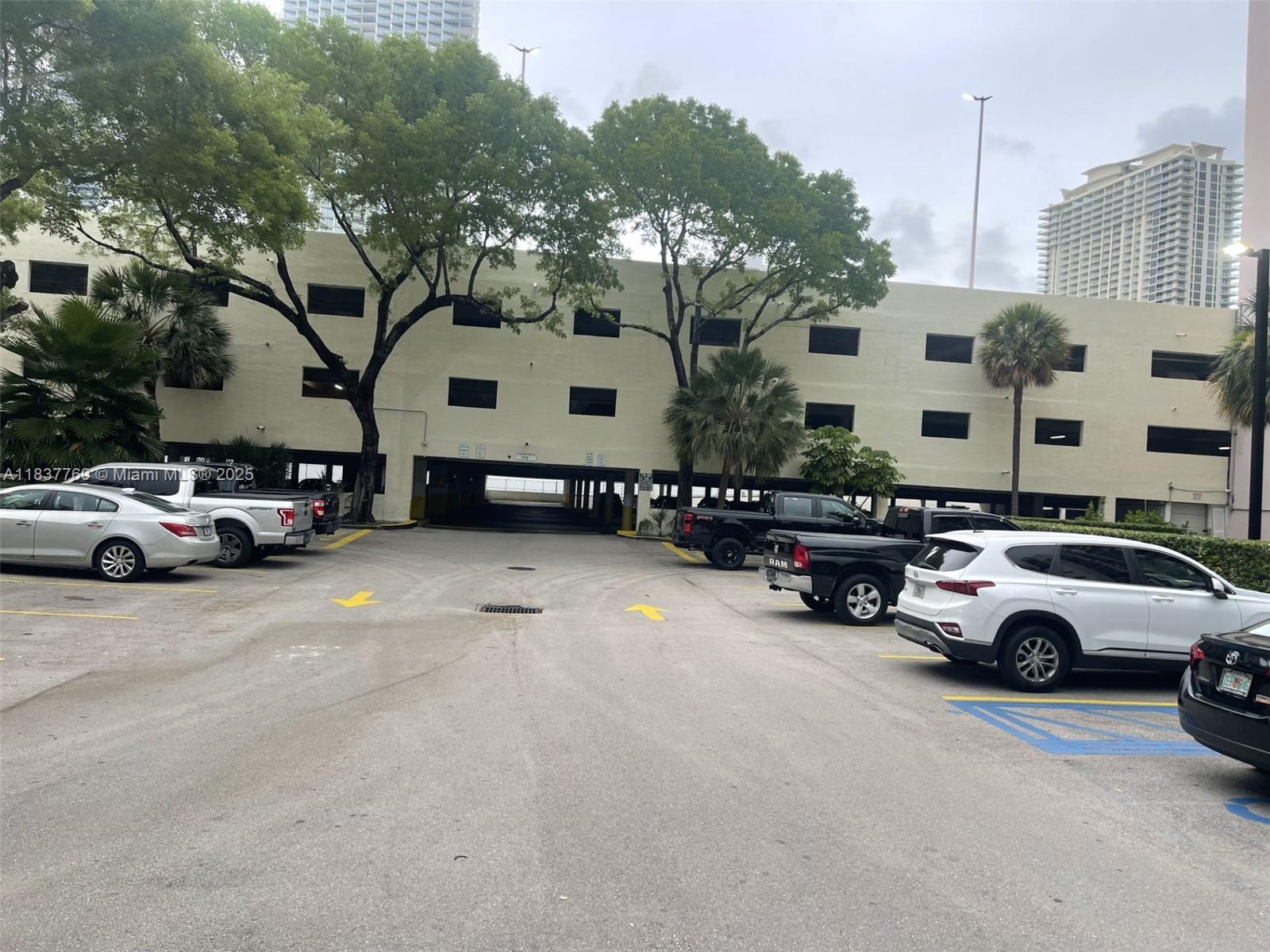 17011 North Bay Road, Unit 406 Sunny Isles Beach, FL 33160 - Photo 9 of 12 a view of street with parked cars