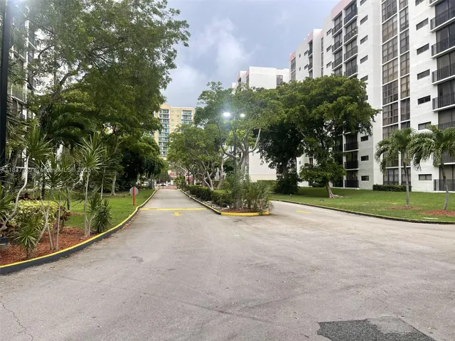 a view of a street with a building in the background