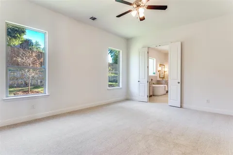 an empty room with windows and cabinet