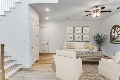 a living room with furniture and a chandelier