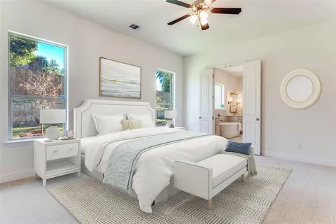 a bedroom with a large bed and a chandelier