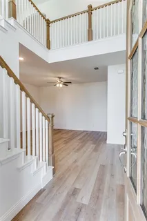 a view of staircase with white walls and a window