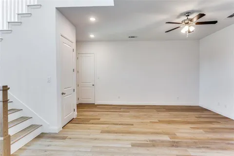 a view of an empty room with stairs and ventilation
