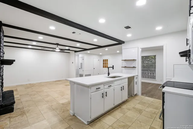 a kitchen with a sink stove and cabinets