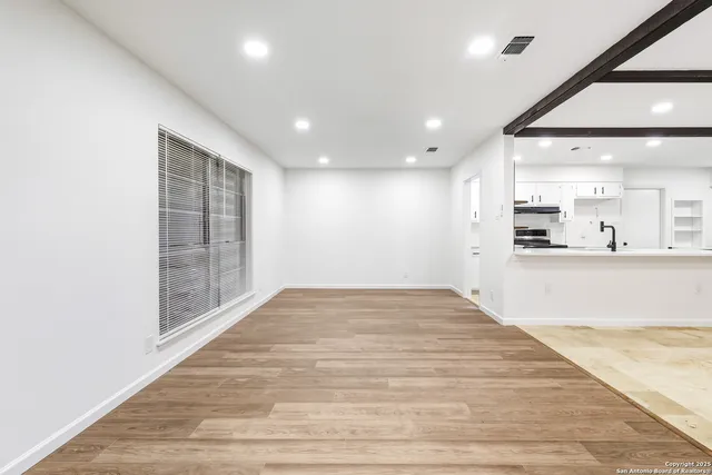 a view of kitchen and hall with wooden floor