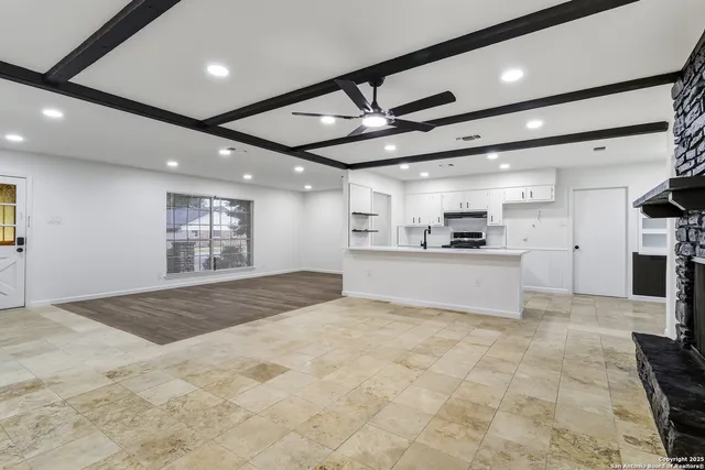 a view of kitchen with refrigerator and window