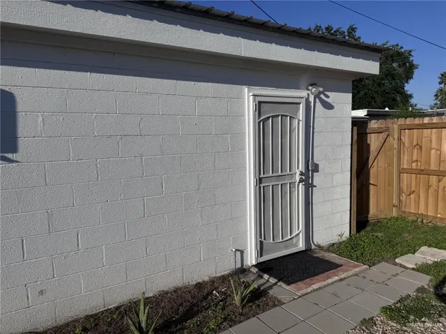 a view of a house with a wooden fence