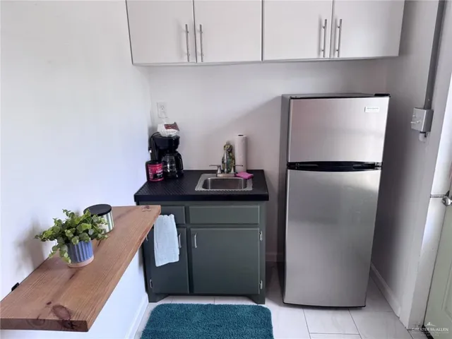 a kitchen with a refrigerator and a cabinets