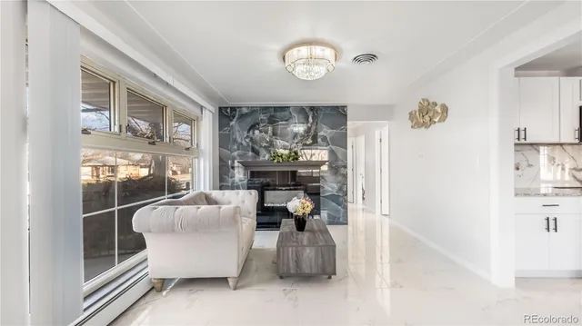 a living room with furniture and a floor to ceiling window