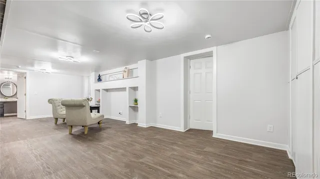 a view of a room with wooden floor furniture and a window