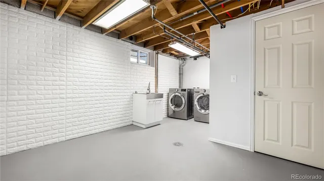 a utility room with sink dryer and washer