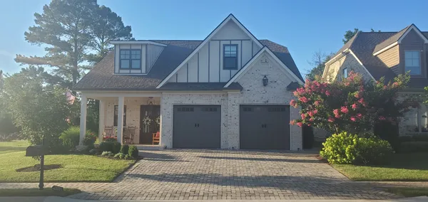 a front view of a house with garden
