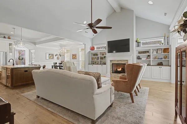 a living room with fireplace furniture and a flat screen tv