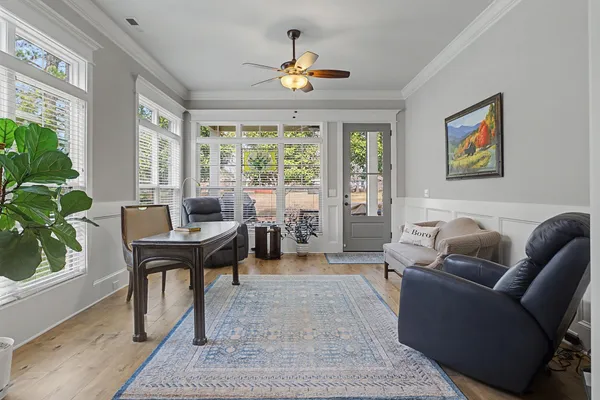 a living room with furniture a window and a potted plant