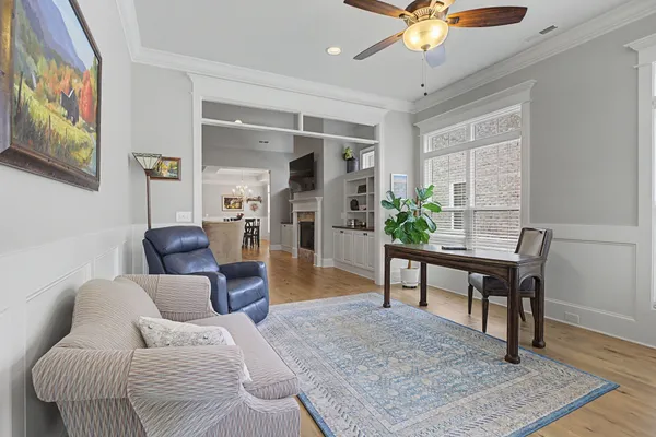 a living room with furniture and wooden floor