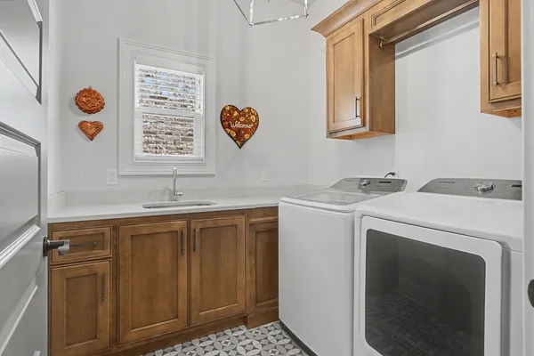 a utility room with a sink and a washer dryer