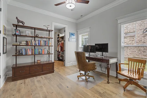 a view of a workspace with furniture and a window