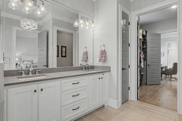 a bathroom with a double vanity sink and a mirror
