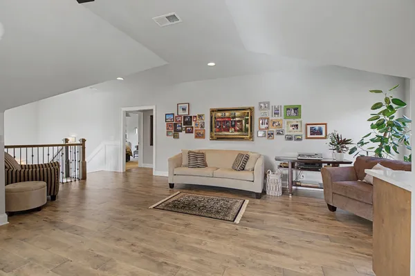 a living room with furniture and a wooden floor