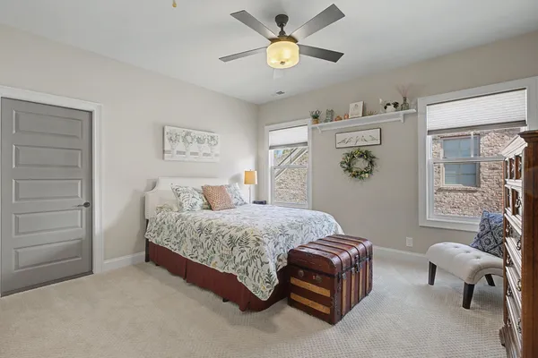 a spacious bedroom with a bed and a window