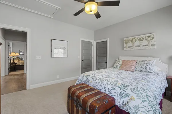 a bedroom with a large bed and a chandelier