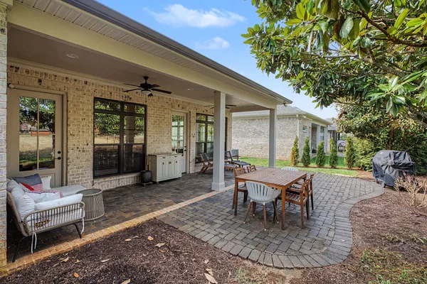 a building outdoor space with patio furniture and potted plants