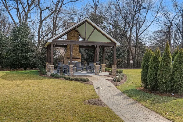 a view of a house with swimming pool and sitting area