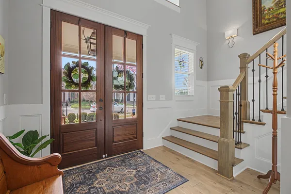 a view of an entryway with wooden floor and door