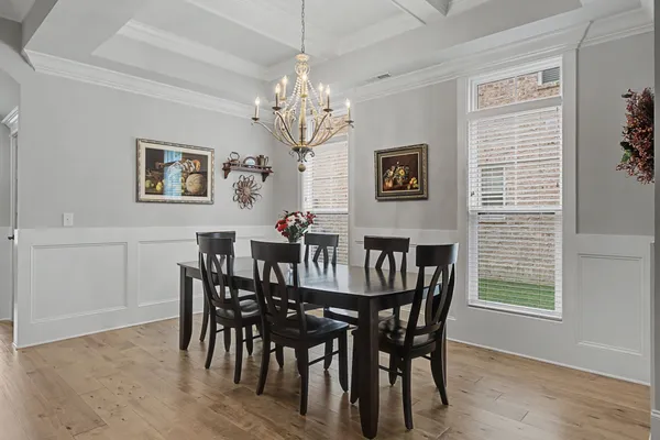 a view of a dining room with furniture and chandelier