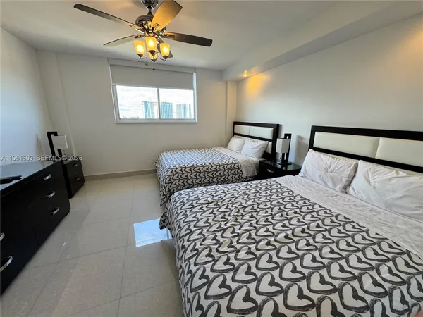 a bedroom with double bed and a window