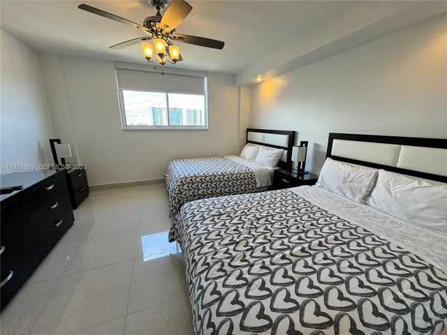 a bedroom with double bed and a window