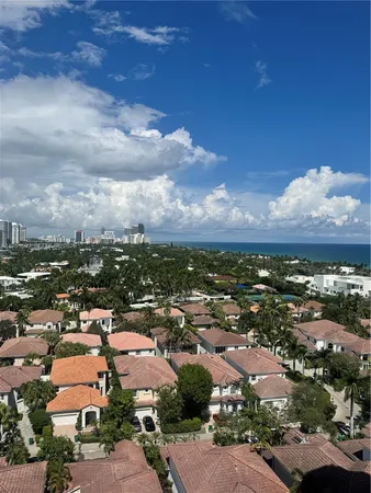 an aerial view of residential houses with city view