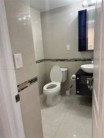 a bathroom with a toilet a sink and a mirror